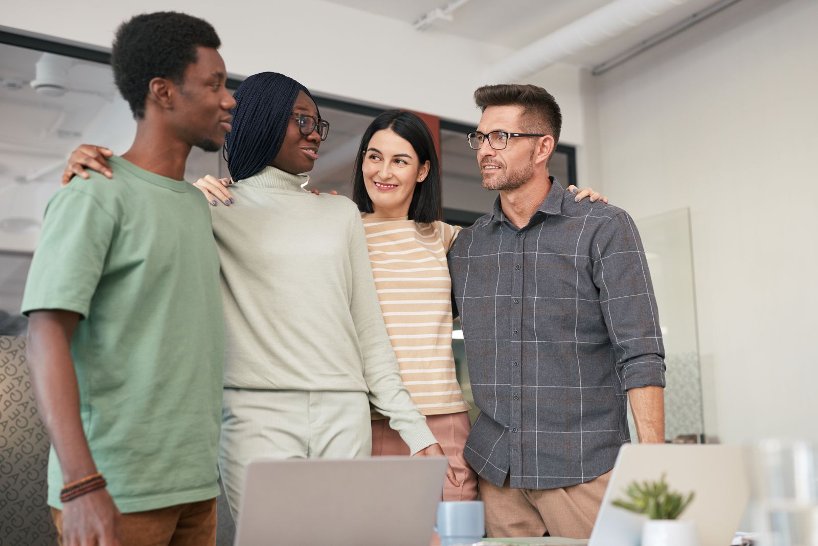 A diverse group of colleagues standing together in a workplace