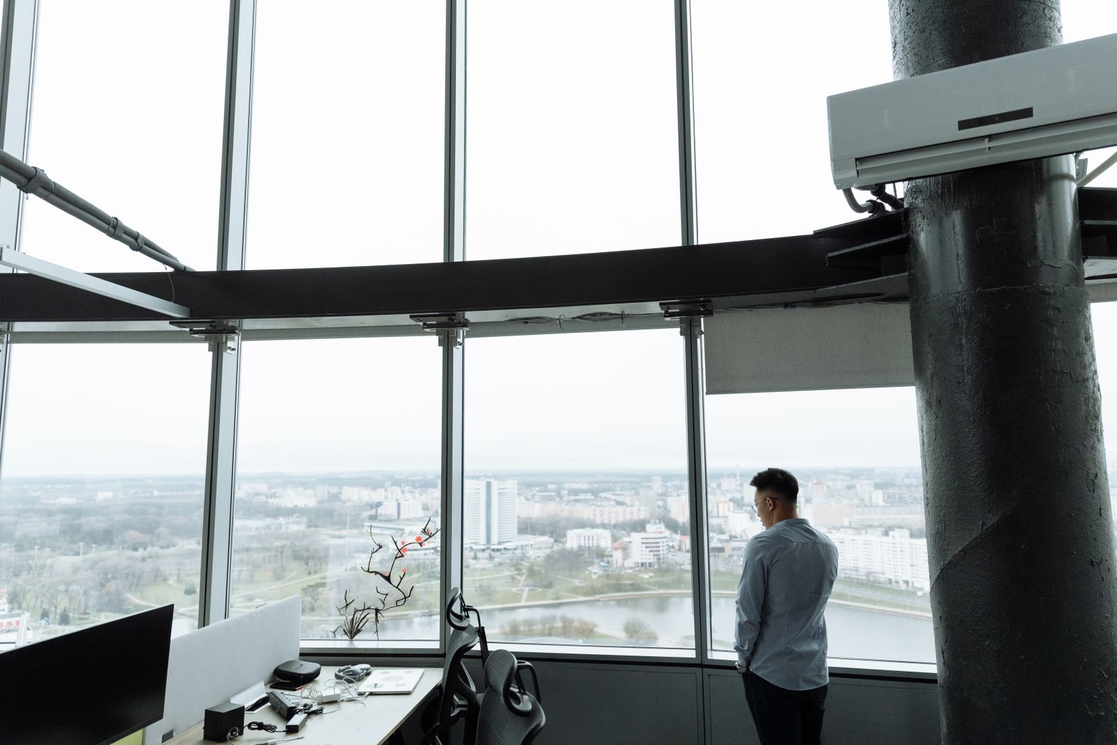 A business leader looking out over a city from a high-rise office